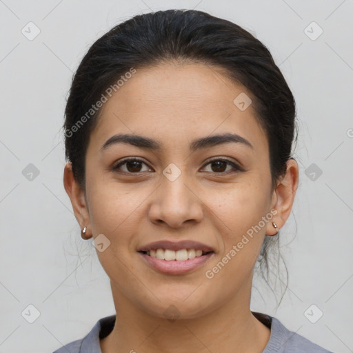 Joyful latino young-adult female with short  brown hair and brown eyes