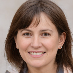 Joyful white adult female with medium  brown hair and brown eyes