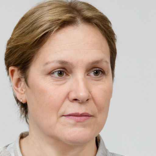 Joyful white adult female with medium  brown hair and grey eyes