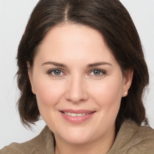 Joyful white young-adult female with medium  brown hair and brown eyes