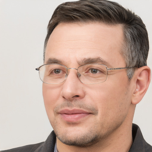 Joyful white adult male with short  brown hair and brown eyes