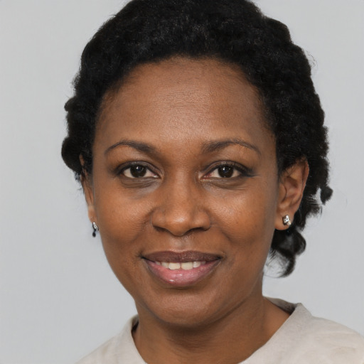 Joyful black adult female with short  black hair and brown eyes