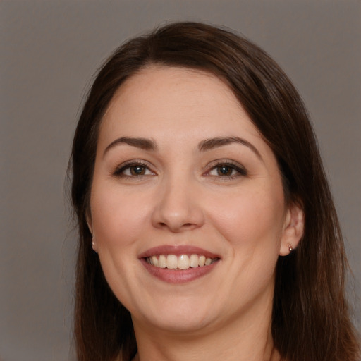 Joyful white young-adult female with long  brown hair and brown eyes