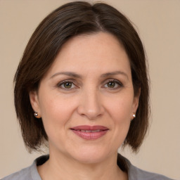 Joyful white adult female with medium  brown hair and brown eyes