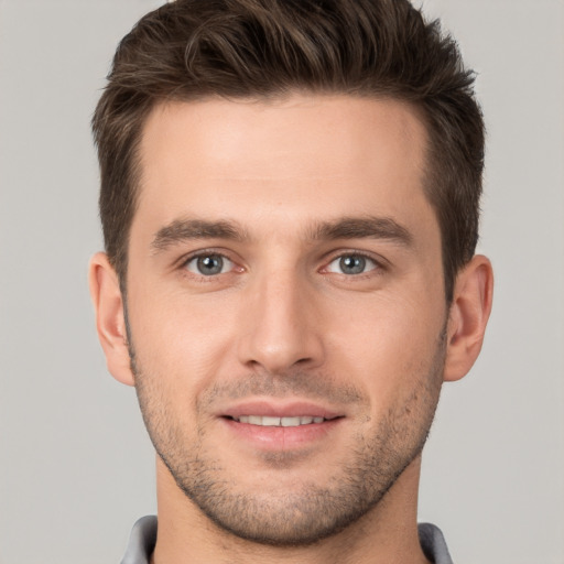 Joyful white young-adult male with short  brown hair and brown eyes