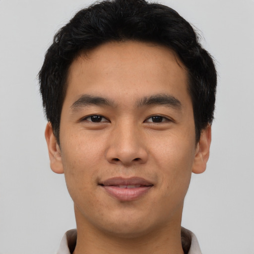 Joyful asian young-adult male with short  brown hair and brown eyes