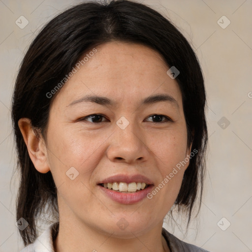 Joyful asian adult female with medium  brown hair and brown eyes