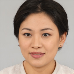 Joyful asian young-adult female with medium  brown hair and brown eyes