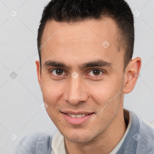 Joyful white young-adult male with short  brown hair and brown eyes