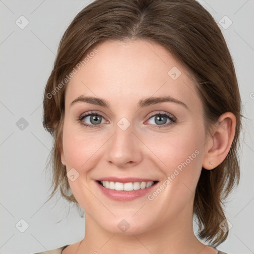 Joyful white young-adult female with medium  brown hair and blue eyes