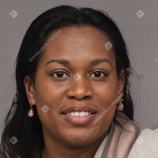 Joyful black young-adult female with long  brown hair and brown eyes