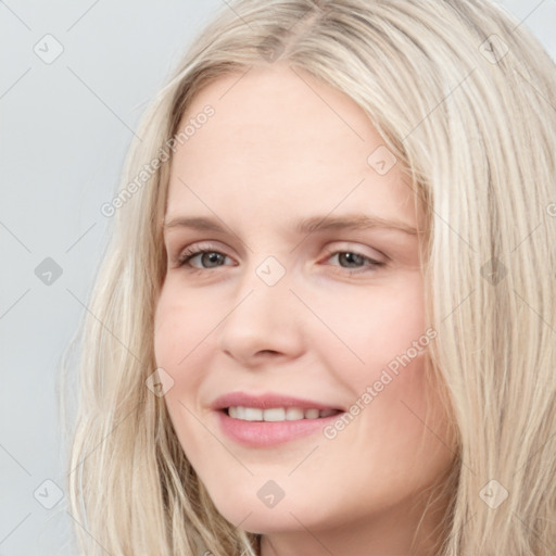 Joyful white young-adult female with long  brown hair and blue eyes