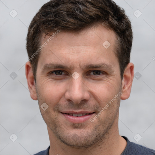 Joyful white adult male with short  brown hair and grey eyes