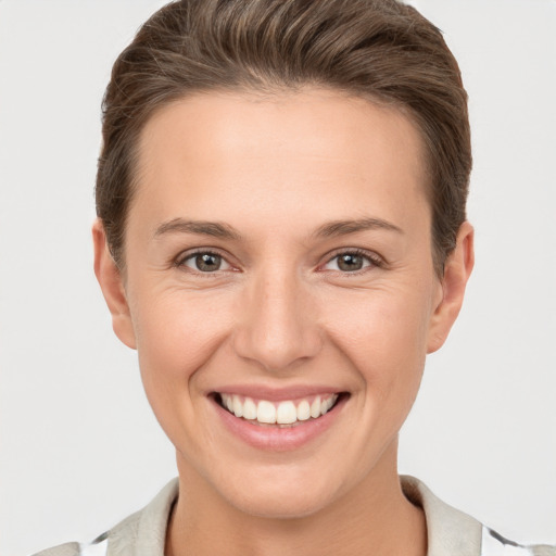 Joyful white young-adult female with short  brown hair and brown eyes