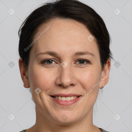 Joyful white adult female with medium  brown hair and grey eyes