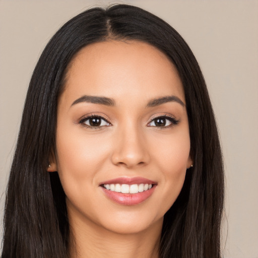 Joyful latino young-adult female with long  black hair and brown eyes