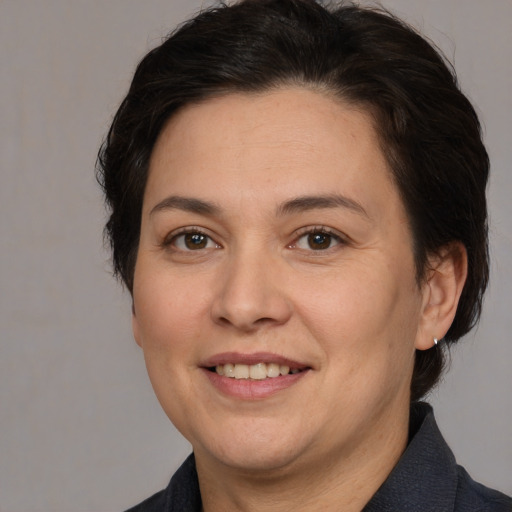 Joyful white adult female with medium  brown hair and brown eyes