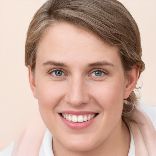 Joyful white young-adult female with medium  brown hair and grey eyes