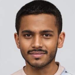 Joyful black young-adult male with short  brown hair and brown eyes