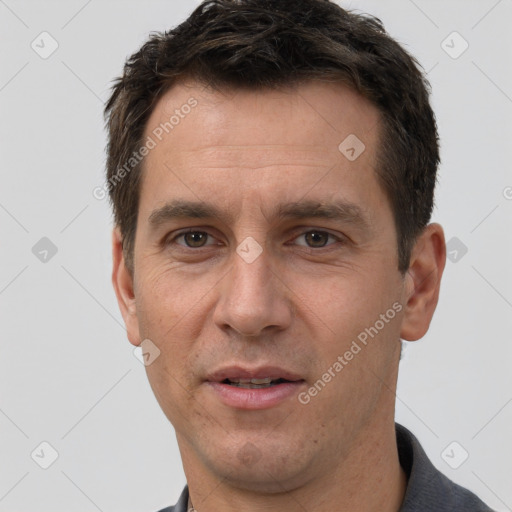 Joyful white adult male with short  brown hair and brown eyes