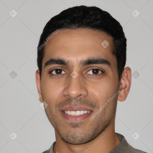 Joyful latino young-adult male with short  black hair and brown eyes