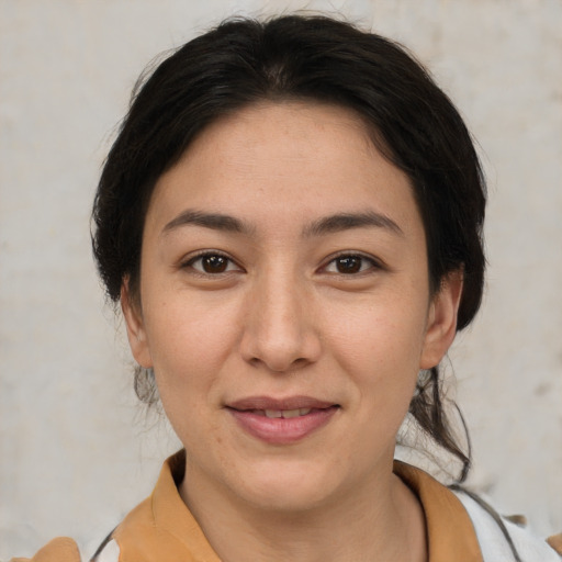 Joyful asian young-adult female with medium  brown hair and brown eyes