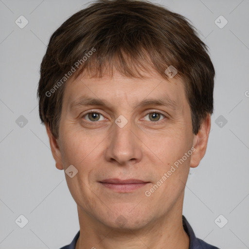 Joyful white adult male with short  brown hair and grey eyes