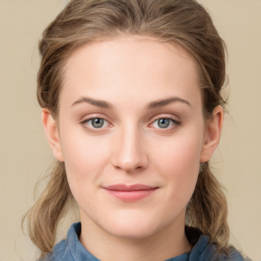 Joyful white young-adult female with medium  brown hair and blue eyes