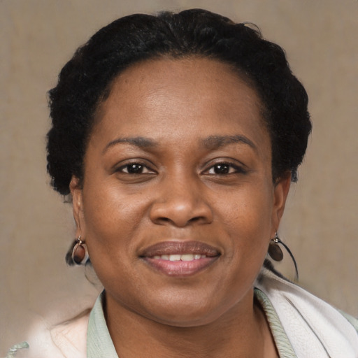 Joyful black adult female with short  black hair and brown eyes
