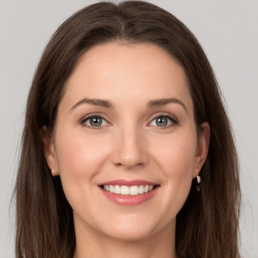 Joyful white young-adult female with long  brown hair and grey eyes