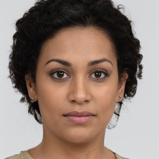 Joyful latino young-adult female with short  brown hair and brown eyes
