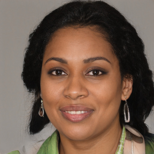 Joyful black young-adult female with medium  black hair and brown eyes