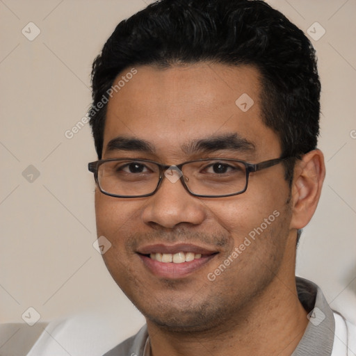 Joyful white young-adult male with short  black hair and brown eyes