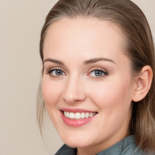 Joyful white young-adult female with long  brown hair and blue eyes