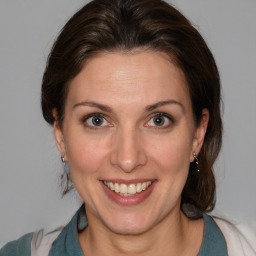 Joyful white adult female with medium  brown hair and blue eyes