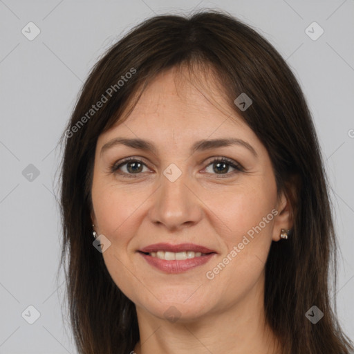 Joyful white adult female with long  brown hair and brown eyes