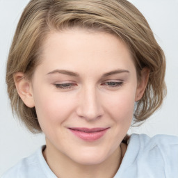 Joyful white young-adult female with medium  brown hair and blue eyes