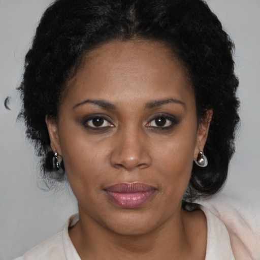 Joyful black adult female with medium  brown hair and brown eyes