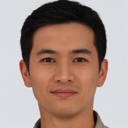 Joyful asian young-adult male with short  black hair and brown eyes