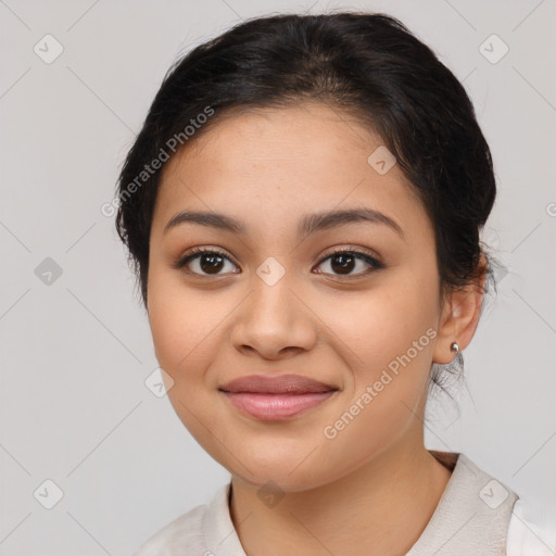 Joyful latino young-adult female with medium  brown hair and brown eyes