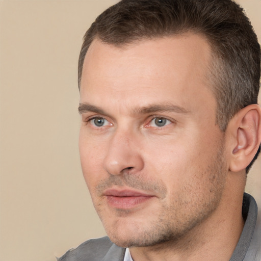 Joyful white adult male with short  brown hair and brown eyes