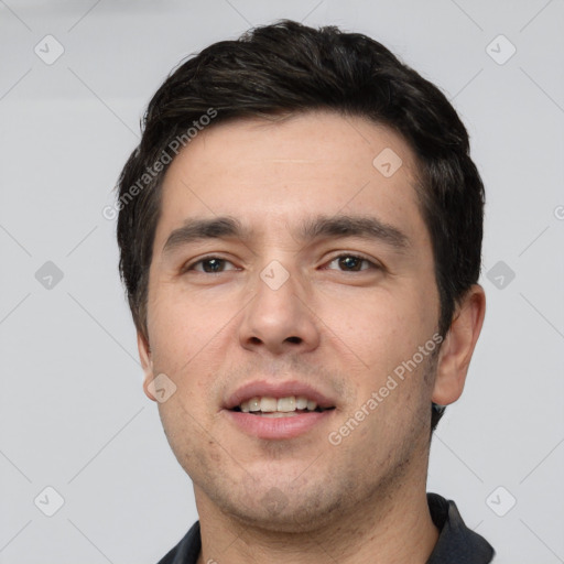 Joyful white young-adult male with short  black hair and brown eyes