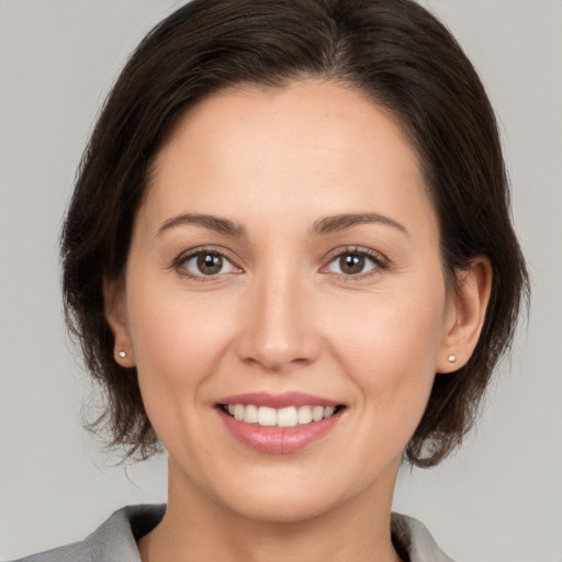 Joyful white young-adult female with medium  brown hair and brown eyes