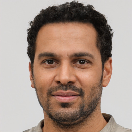 Neutral latino adult male with short  black hair and brown eyes