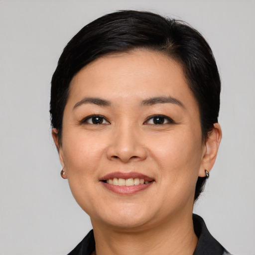 Joyful white young-adult female with short  black hair and brown eyes