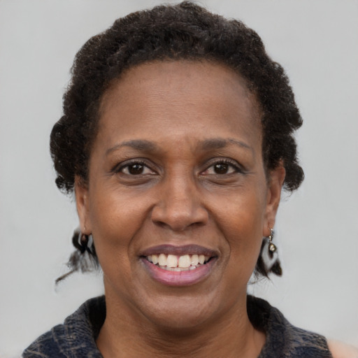 Joyful black adult female with short  brown hair and brown eyes