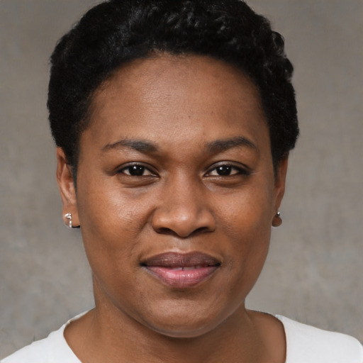 Joyful black young-adult female with short  black hair and brown eyes