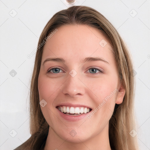 Joyful white young-adult female with long  brown hair and blue eyes