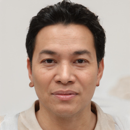 Joyful asian adult male with short  brown hair and brown eyes