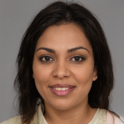 Joyful latino young-adult female with medium  brown hair and brown eyes